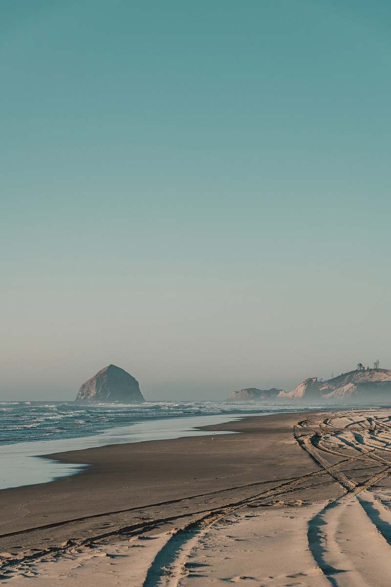 pacific city rock formation on water near seashore at daytime beach